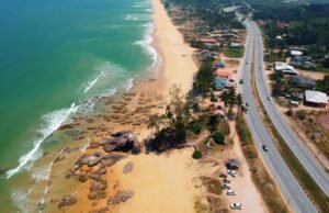 Stunning aerial view of Kuala Dungun beach and coastal road in Terengganu, Malaysia.